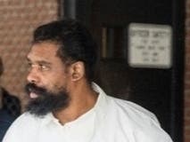 Ramapo police officers escort Grafton Thomas from Ramapo Town Hall to a police vehicle, Sunday, Dec. 29, 2019. 