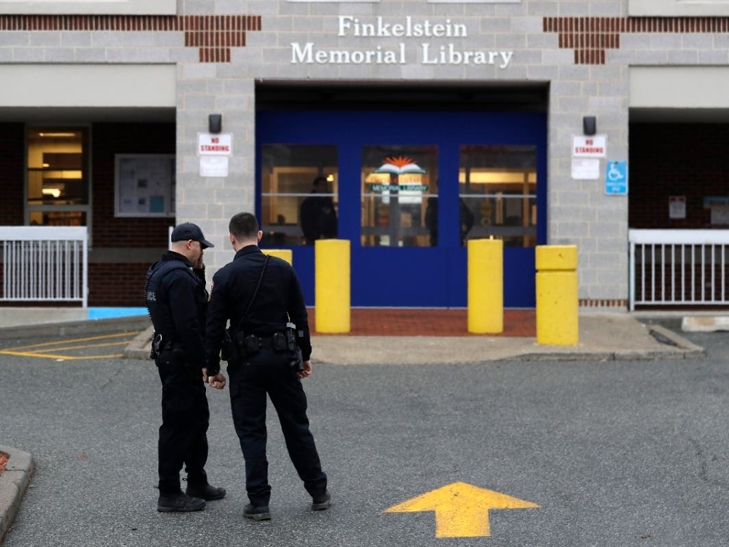 Police stand in front of the Finkelstein Memorial Library in Spring Valley Feb. 18 after a security guard was fatally stabbed on the third floor.