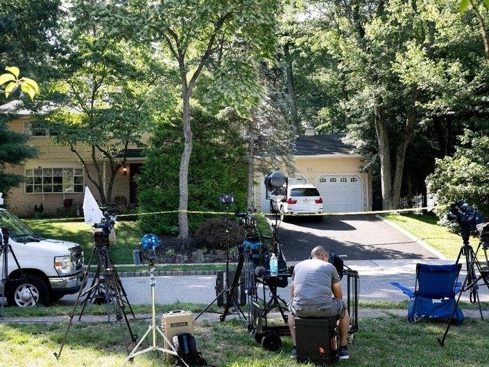 News media set up Monday in front of the home of U.S. District Judge Esther Salas in northern New Jersey. A gunman shot and killed Salas' son and wounded her husband Sunday evening.
