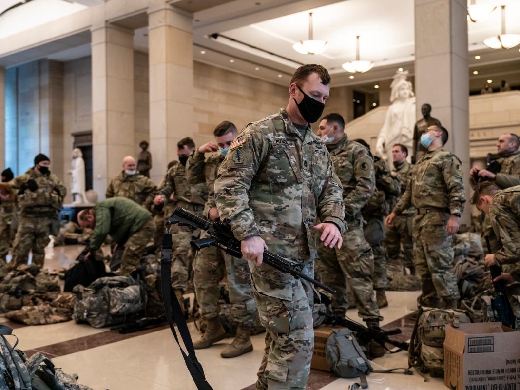 Hundreds of National Guard troops hold inside the Capitol Visitor's Center to reinforce security at the Capitol in Washington, Wednesday, Ja