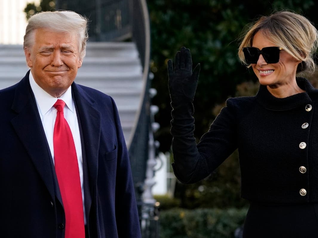 President Donald Trump and first lady Melania Trump stop to talk with the media as they walk to board Marine One on the South Lawn of the White House, Wednesday, Jan. 20, 2021, in Washington. Trump is en route to his Mar-a-Lago Florida Resort. 