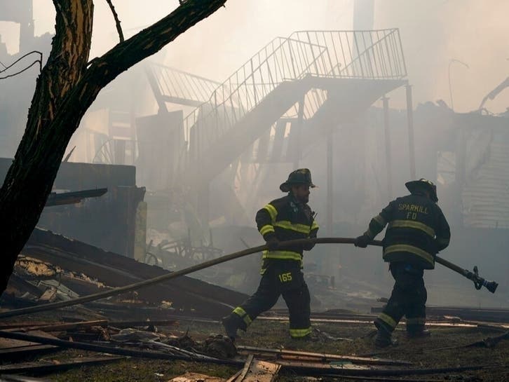 Firefighters worked on extinguishing hotspots from a fatal fire that burned down the Evergreen Court Home for Adults March 23, 2021, in Spring Valley.