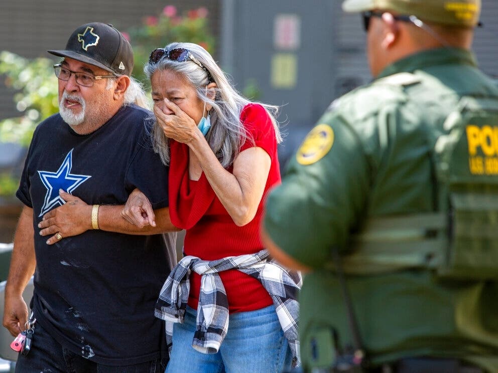 A woman cries as she leaves the Uvalde Civic Center, Tuesday May 24, 2022, in Uvalde, Texas. An 18-year-old gunman opened fire Tuesday at a Texas elementary school, killing multiple children and adults and wounding others.