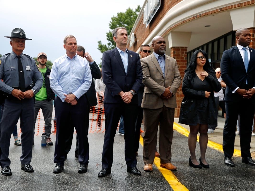 Virginia Gov. Ralph Northam, center, attends a vigil June 1 in response to the Virginia Beach mass shooting.