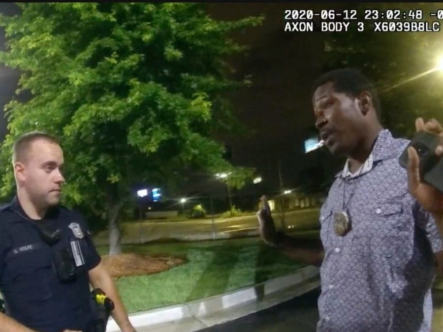 This image taken from body camera video provided by the Atlanta Police Department shows Rayshard Brooks speaking with former Officer Garrett Rolfe in the parking lot of a Wendy's restaurant, late Friday, June 12, in Atlanta. Rolfe shot Brooks as he fled.