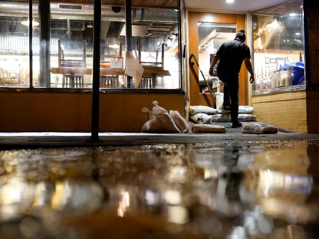Konrad Karandy of Annapolis puts sandbags in front of a restaurant in downtown Annapolis, Thursday, Oct. 28, as the water from tidal flooding rises. The city is anticipating potential historic tidal flooding conditions in low-lying areas.