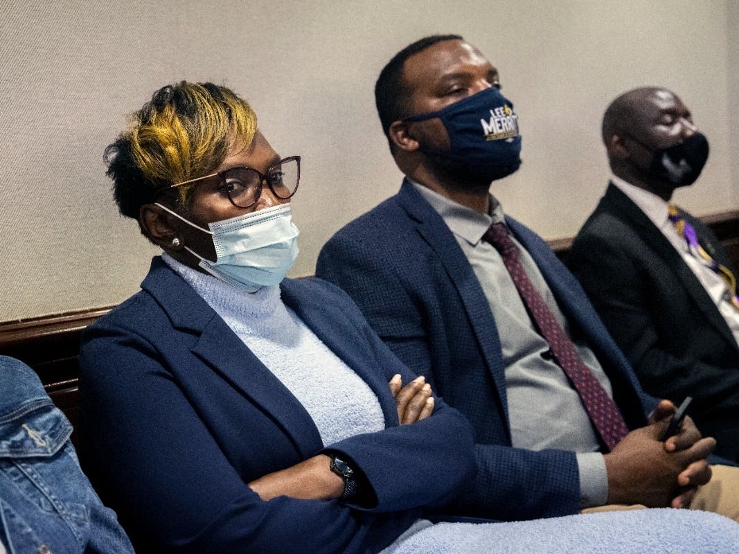 Ahmaud Arbery's mother, Wanda Cooper-Jones (left), along with her attorney Lee Merritt (center), listen to William "Roddie" Bryan's attorney present his closing statement to the jury during the trial of the three men convicted in Arbery's death.