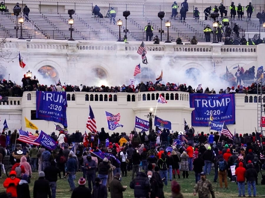 Insurrectionists loyal to President Donald Trump swarm the Capitol, Jan. 6, 2021, in Washington. More than a dozen Maryland residents face charges stemming from the attack; some fought with police and others livestreamed the violence, the FBI said.
