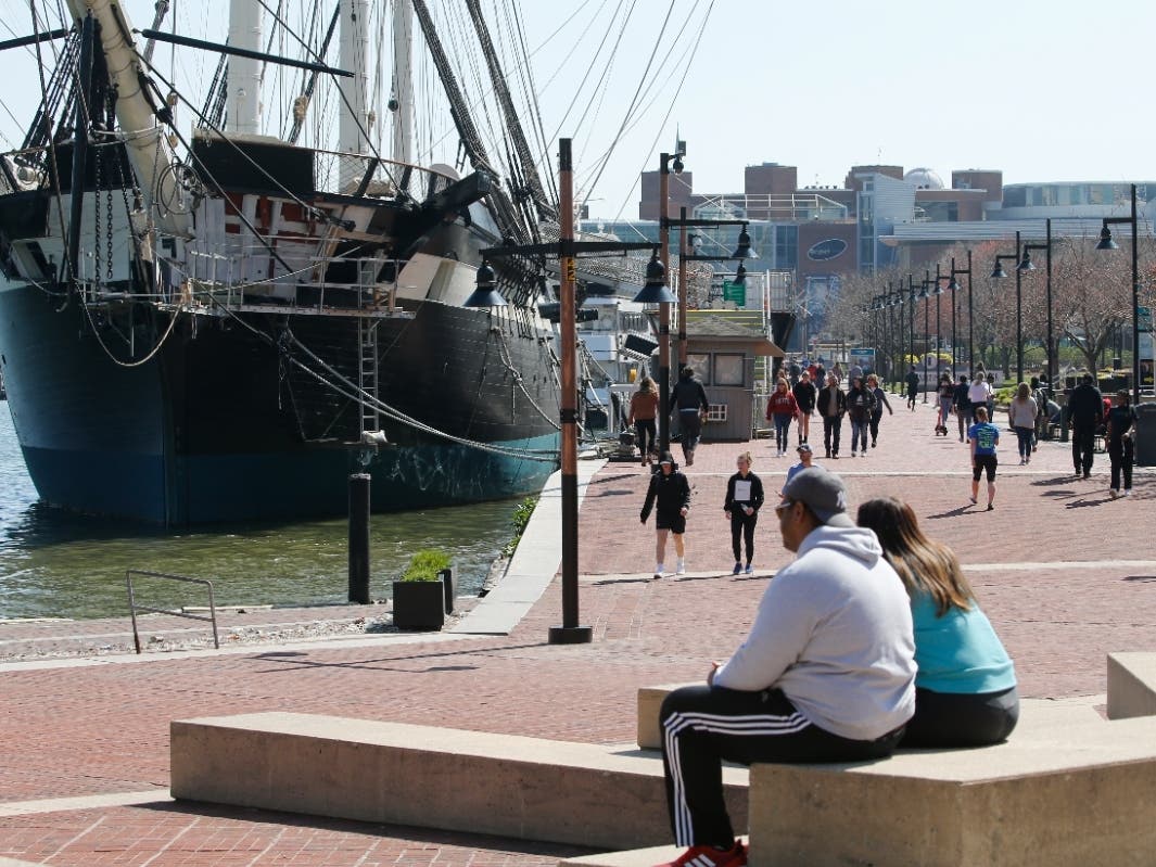 Visitors to Baltimore's Inner Harbor practice social distancing as they enjoy the waterfront March 26, 2020. Baltimore is one of two Maryland cities named to the nation’s 150 Best Places to Live by U.S. News & World Report.