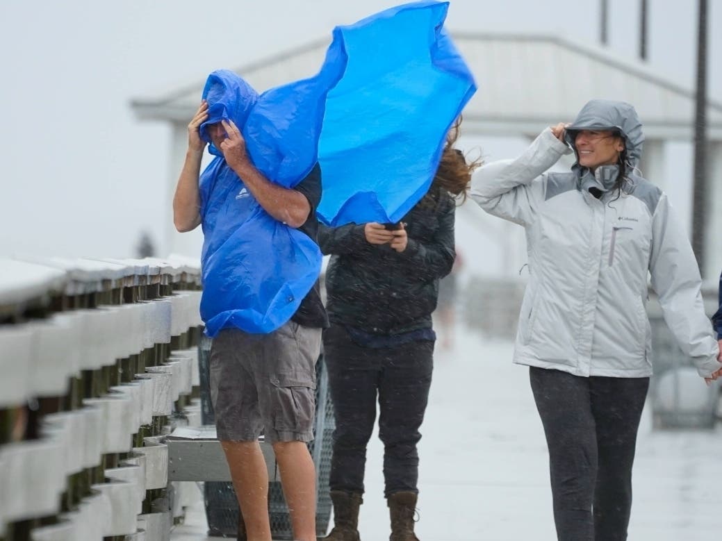 People walk on the Ballast Point Pier in Tampa ahead of Hurricane Ian, Wednesday, Sept. 28. Gov. Larry Hogan urged Marylanders to prepare for weekend rains from Ian. Gale warnings and watches are in effect along the Bay, as well as coastal flood watches.