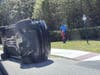 Golfer Tiger Woods stands by his overturned vehicle in Jupiter Island, Fla., on Friday, March 27, 2026.