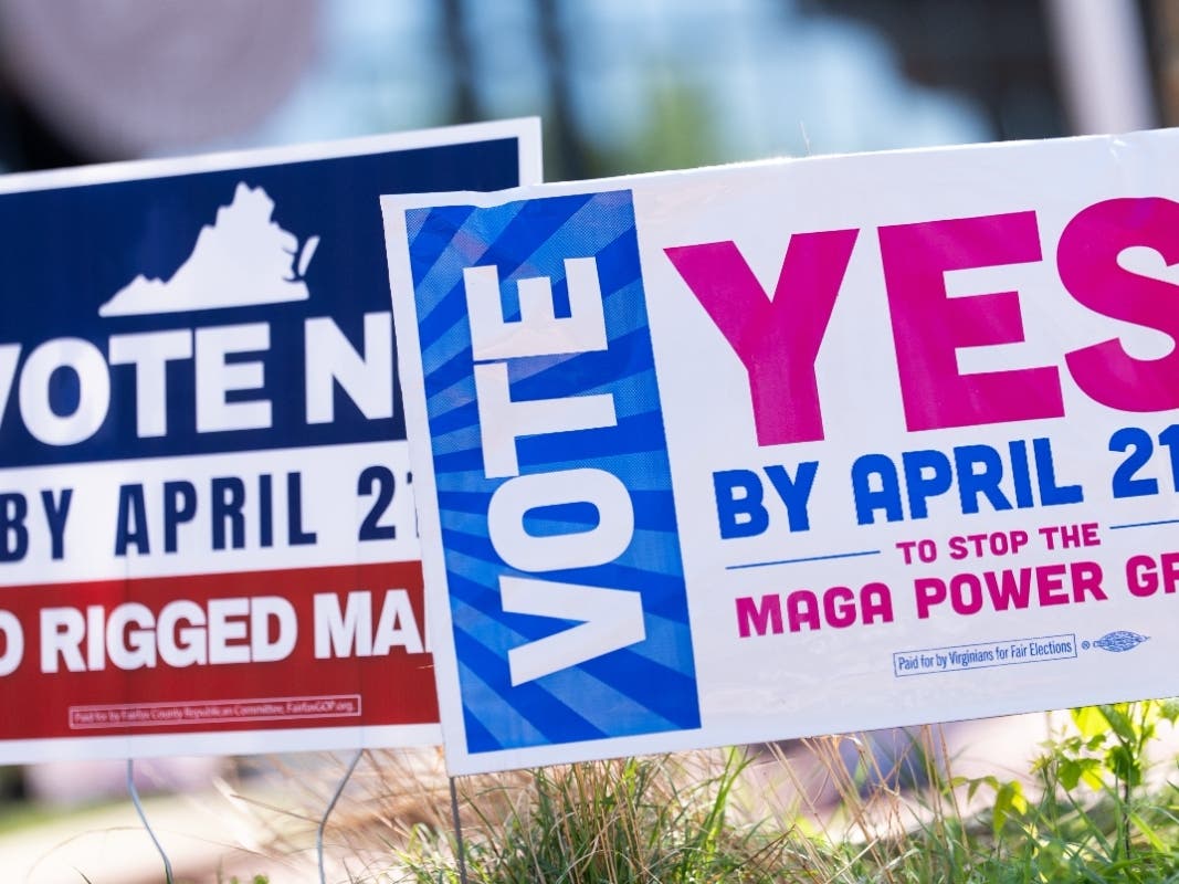 Signs are seen outside Fairfax Government Center during the Virginia redistricting referendum, Tuesday, April 21, 2026, in Fairfax, Virginia. A judge ruled the results of the vote could not be certified, but the state says it will appeal.