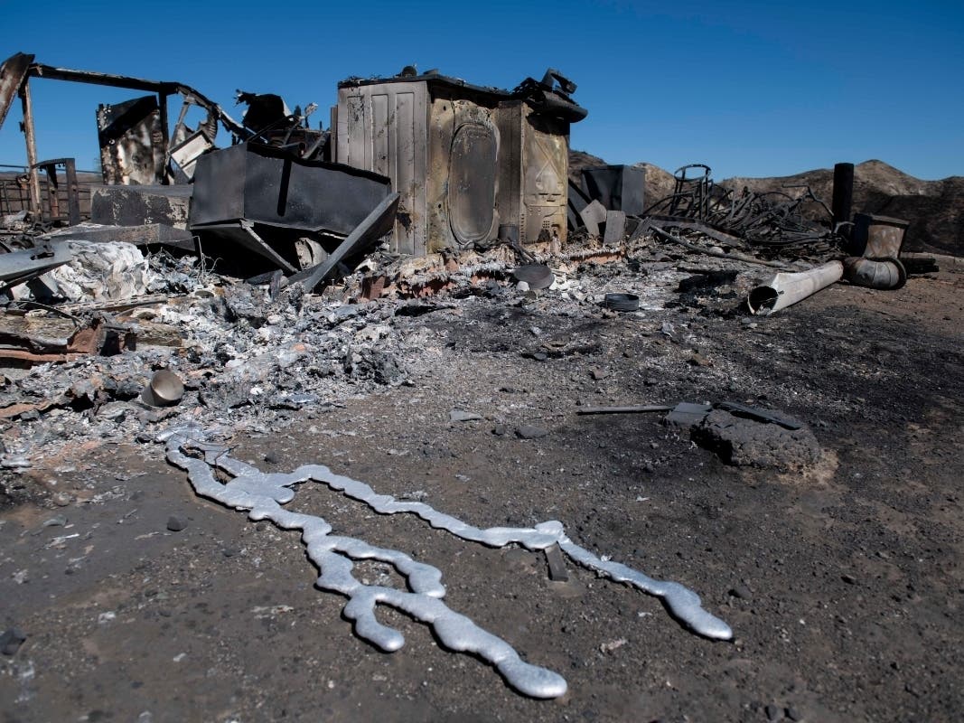 Debris from a hilltop home smolders after being burned by the Tick Fire, Thursday, Oct. 25, 2019, in Santa Clarita.