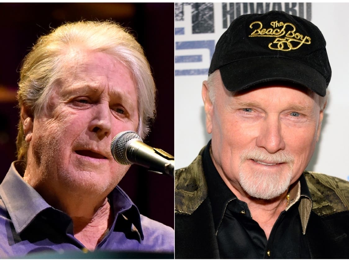 This combination photo shows Brian Wilson and Mike Love. Wilson, a co-founder of The Beach Boys, has denounced a performance of Beach Boys music at the Safari Club International Convention led by Love. 