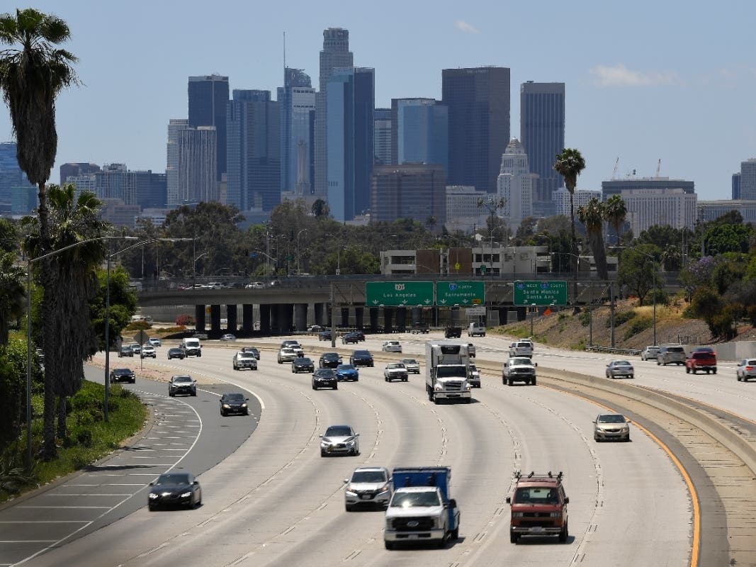 Traffic moves along Interstate 10 as downtown Los Angeles is seen in the background during the coronavirus outbreak, Tuesday, May 19, 2020, in Los Angeles.