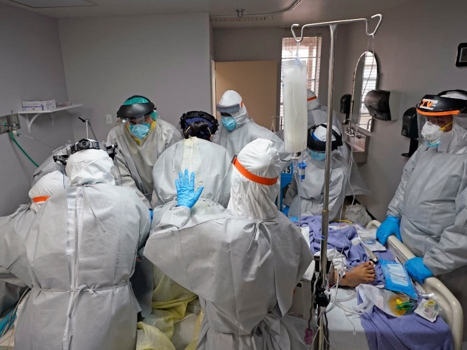 Doctors work unsuccessfully to save a coronavirus patient  inside the Coronavirus Unit at United Memorial Medical Center, Monday, July 6, 2020, in Houston.