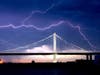 Lightning forks over the San Francisco-Oakland Bay Bridge as a storm passes over Oakland, Calif., Sunday, Aug. 16, 2020. Numerous lightning strikes early Sunday sparked brush fires throughout the region.