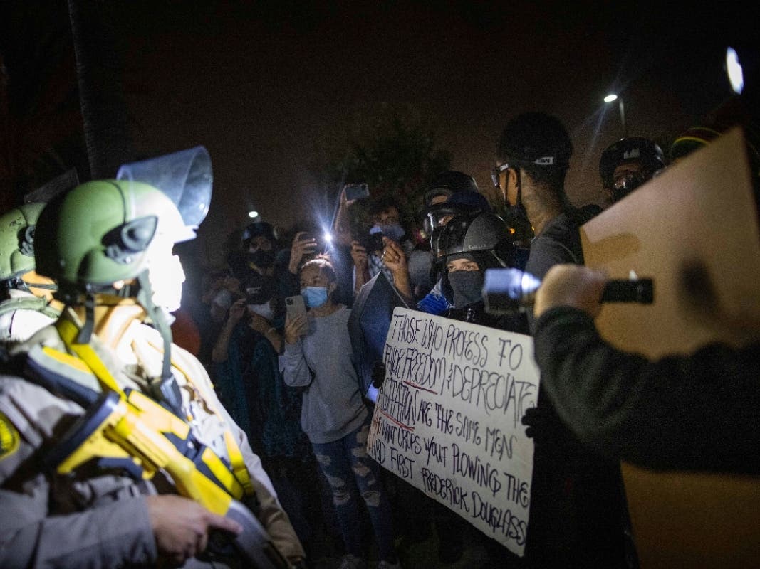 Protesters clash with deputies of the Los Angeles Sheriff's Department during protests following the death of Dijon Kizzee on Monday, Aug. 31, 2020, in Los Angeles, Calif.