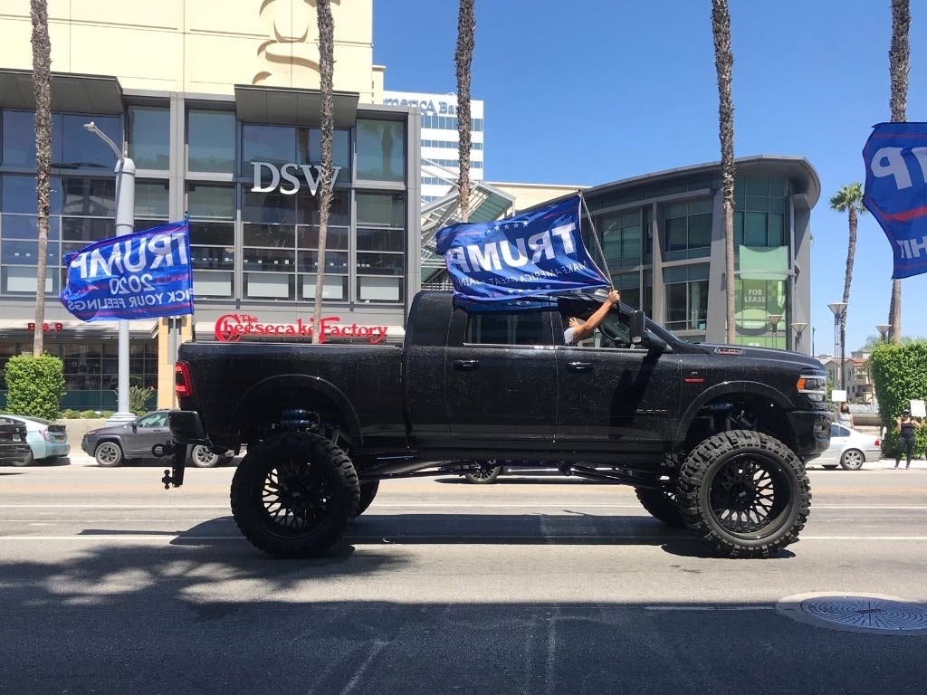 A 4x4 truck joins a Pro-Trump caravan of supporters driving by Black Lives Matter protesters gathered in Los Angeles. A short time later, a caller reported that a man had brandished a gun and fired at least once at passing cars.