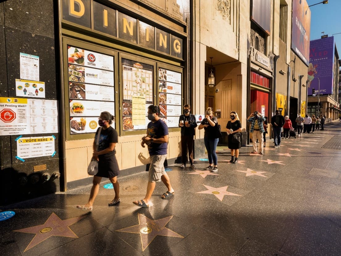 Masked voters lined up outside the Pantages Theatre on election day as the coronavirus outbreak surges again in Los Angeles.