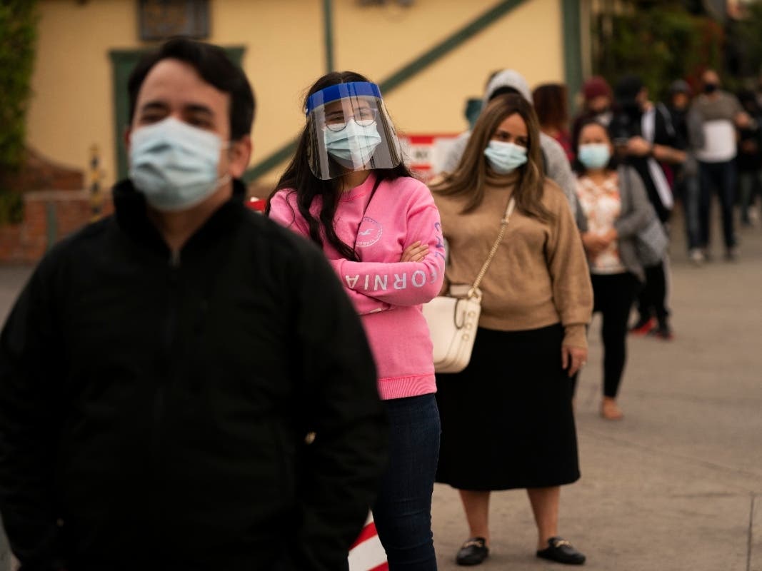In this Monday, Dec. 7, 2020, file photo, people wait in line for COVID-19 testing at a site operated by CORE in Los Angeles. Virtually every state is reporting surges in cases and deaths.