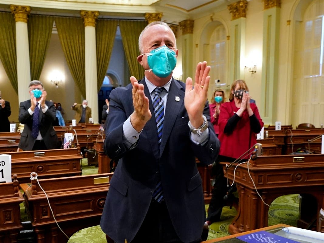 Sacramento Mayor Darrell Steinberg and other members of California's Electoral College applaud after voting for President-Elect Joe Biden for president, in Sacramento, Calif., Monday, Dec. 14, 2020.