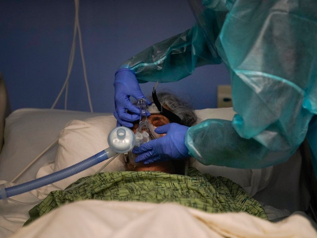 Registered nurse Kyanna Barboza adjusts the ventilator on her COVID-19 patient at St. Joseph Hospital in Orange, Calif., Thursday, Jan. 7, 2021. 