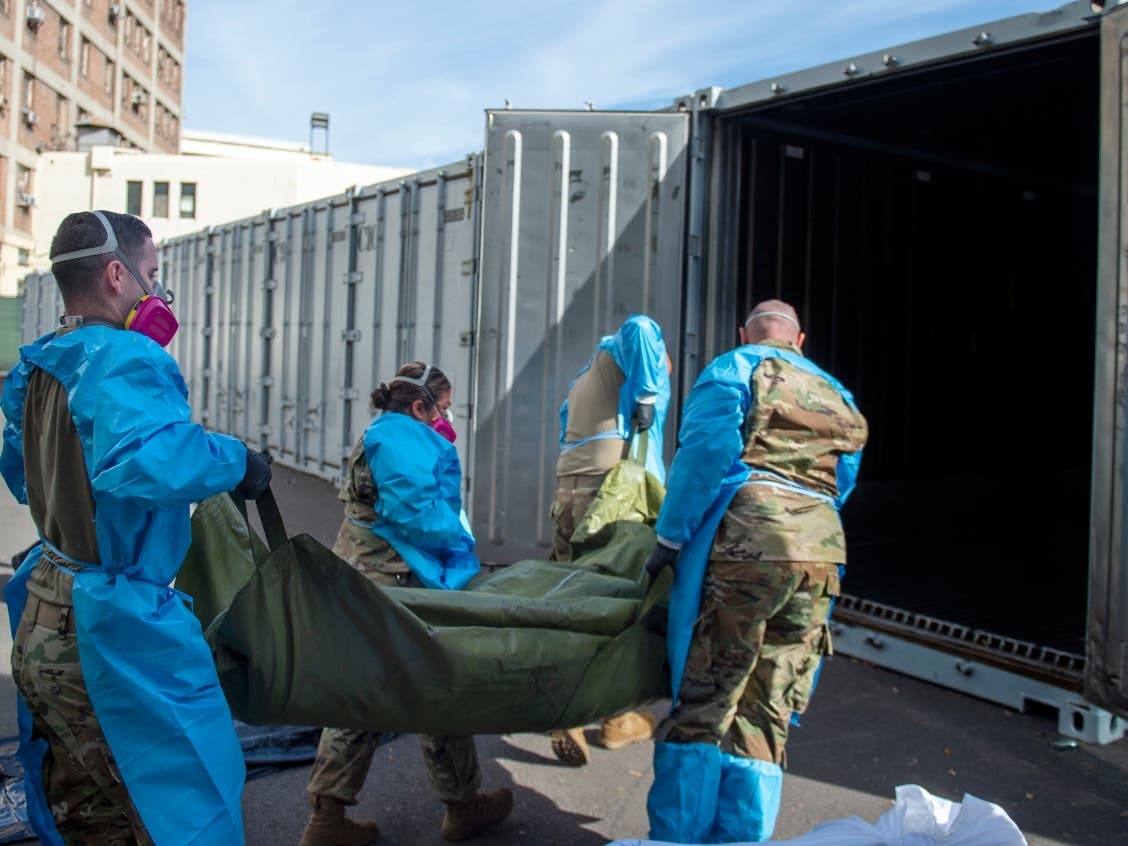 This photo provided by the LA County Dept. of Medical Examiner-Coroner shows National Guard assisting with processing Covid-19 deaths and placing them into temporary storage at LA County Medical Examiner-Coroner Office in Los Angeles on Tuesday, Jan. 12