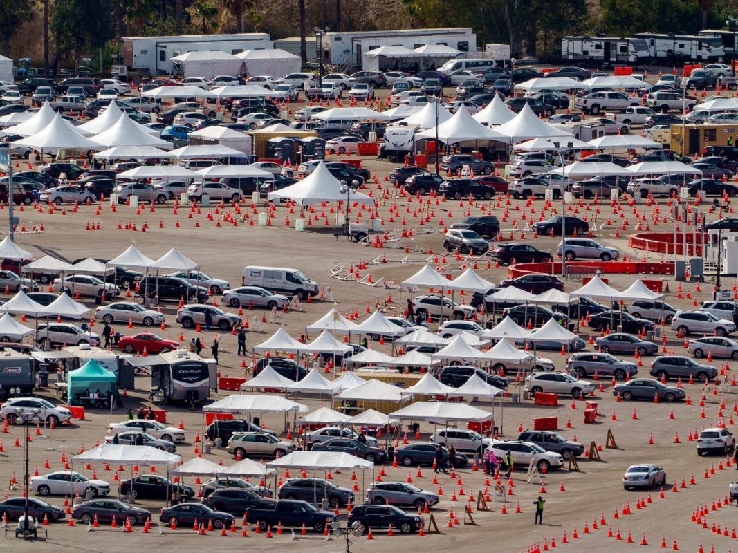  Drivers wait in line at a mega COVID-19 vaccination site set up in the parking lot of Dodger Stadium in Los Angeles. One of the largest vaccination sites in the country temporarily shut down Saturday because dozen of protesters blocked the entrance.