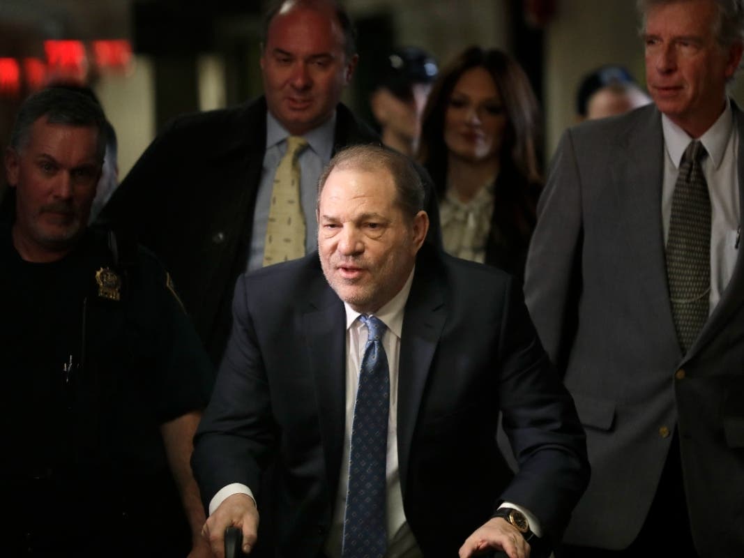 In this Feb. 24, 2020 file photo, Harvey Weinstein arrives at a Manhattan courthouse for jury deliberations in his rape trial in New York. New York prison officials have handed over Weinstein for transport to California to face sexual assault charges. 