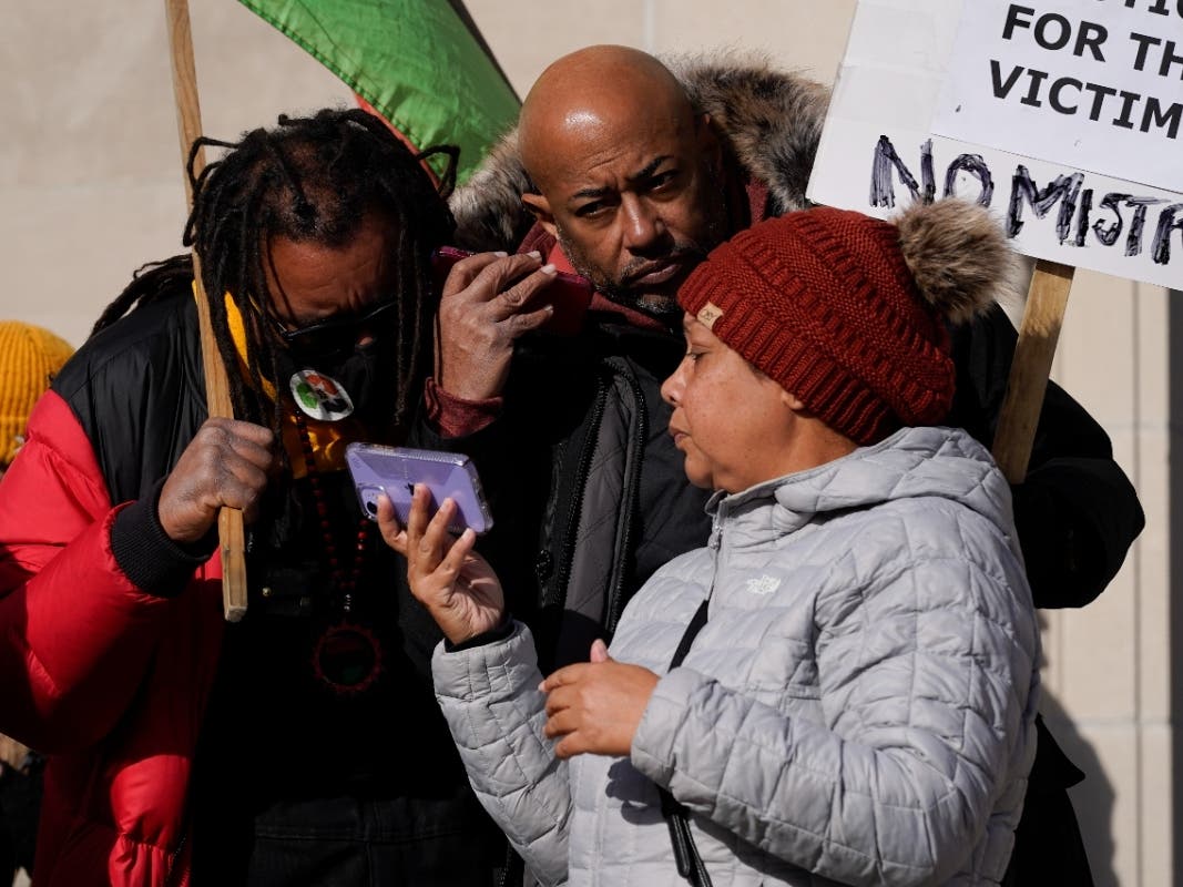 Justin Blake (left), uncle of Jacob Blake, listens to the verdict being read outside the Kenosha County Courthouse on Friday. Kyle Rittenhouse was acquitted of all charges after pleading self-defense in the deadly shooting.
