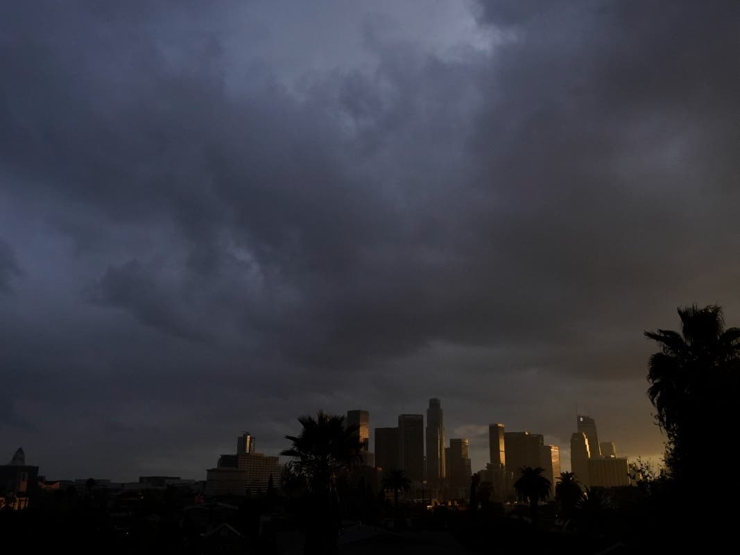 Heavy clouds move over downtown Los Angeles, Monday, Dec. 13, 2021. The storm will bring much-needed moisture to the broader region that's been gripped by drought that scientists have said is caused by climate change. 
