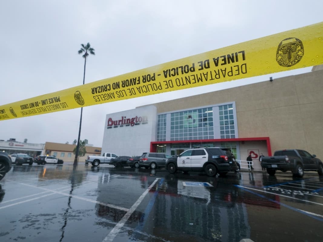 A police yellow tape is seen at the scene where two people were struck by gunfire in a shooting at a Burlington store — part of a chain formerly known as Burlington Coat Factory in North Hollywood, Calif., Thursday, Dec. 23, 2021.