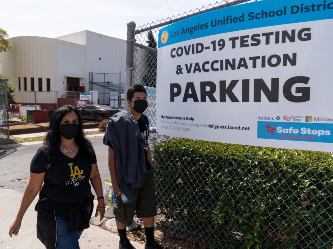 Parent Rosa Vargas and her son, 9th grade student Victor Loredo, 14, walk home after getting tested at a Los Angeles Unified School District COVID-19 testing and vaccination site in East Los Angeles.
