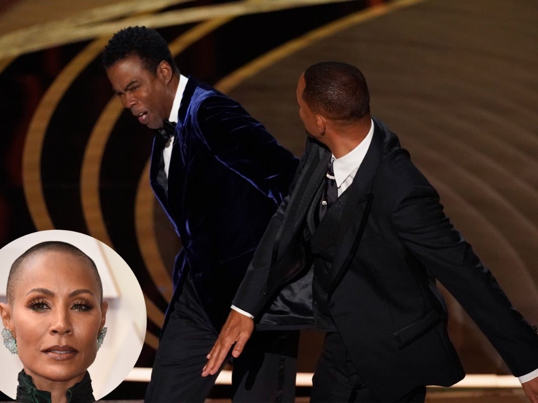Will Smith, right, hits presenter Chris Rock on stage for making a joke about his wife Jada Pinkett Smith while presenting the award for best documentary feature at the Oscars on Sunday, March 27, 2022, at the Dolby Theatre in Los Angeles. 