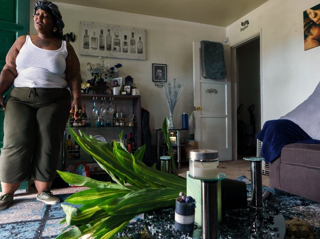 Resident Laquincy Zimmerman shows her bullet-ridden home in Los Angeles, Monday, April 11, 2022. Authorities say several people were killed and wounded in a weekend shooting. Zimmerman said her son was among those shot.