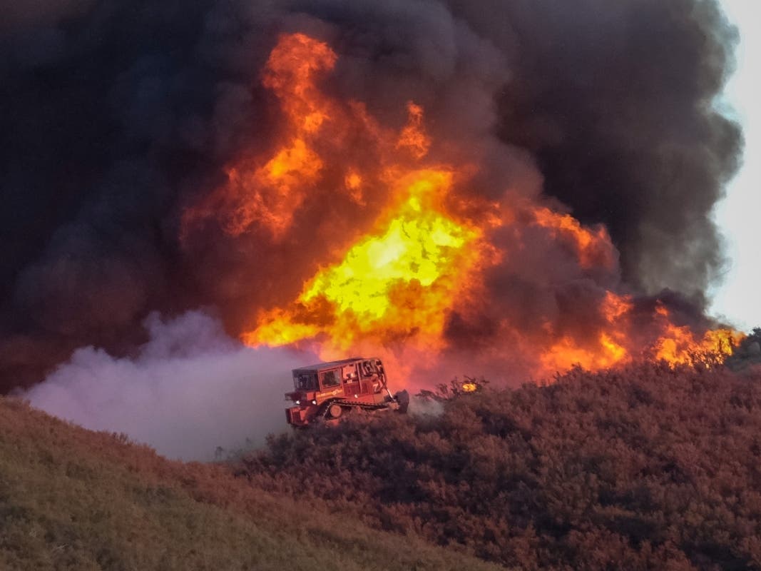 A bulldozer works to build a fire line on wildfire in Castaic, Calif. on Wednesday, Aug. 31, 2022. (AP Photo/Ringo H.W. Chiu)