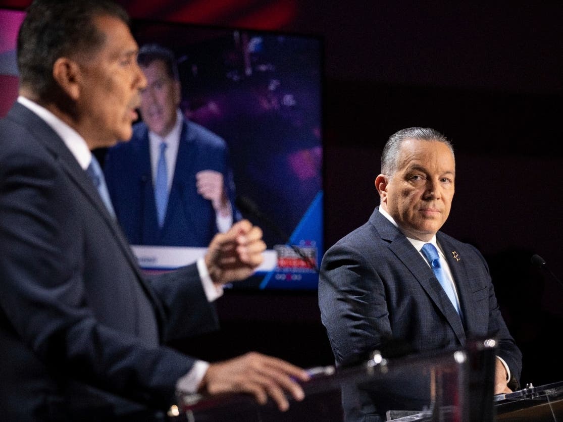 Former Long Beach Police Chief Robert Luna, left, debates Los Angeles County Sheriff Alex Villanueva ahead of the Nov. 8 general election for county sheriff at the Skirball Cultural Center, Wednesday, Sept. 21, 2022, in Los Angeles.