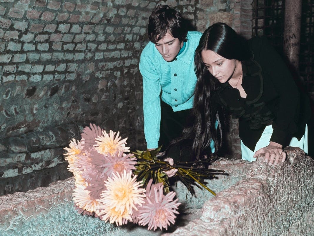 Olivia Hussey and Leonard Whiting, who are played the title roles in Franco Zeffirelli's "Romeo and Juliet," place flowers on the "Tomba di Giulietta", or the Tomb of Juliet, in Verona, Italy, on Oct. 22, 1968. The two stars filed are suing the studio.