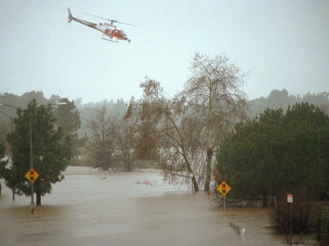 A Los Angeles County fire department helicopter flys over a flooded street in Burbank, Calif., searching for any possible stranded motorists, Tuesday, Feb. 3, 1998. An El Nino-charged storm clobbered Southern California.