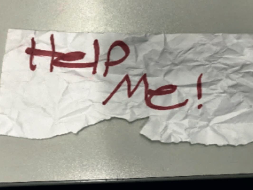In this undated photo released by the U.S Department of Justice is a "Help Me!" sign used by a 13-year-old girl kidnapped in Texas. The girl was rescued in Southern California on July 9, 2023, when passersby saw her hold up the sign in a parked car.