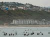 Surfers wait for waves at Doheny State Park Beach off Dana Point, Calif., Sunday, Aug. 20, 2023. Tropical Storm Hilary swirled northward Sunday just off the coast.