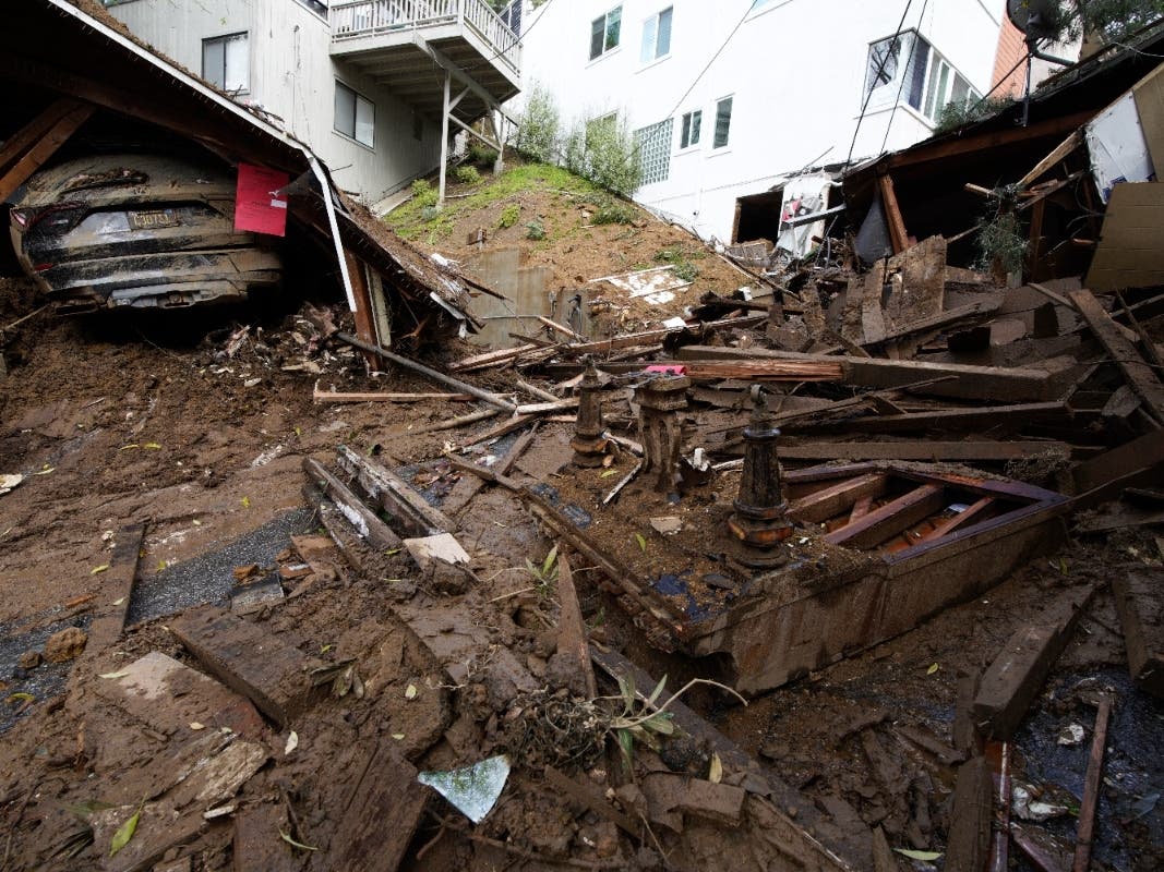 The remains of a piano and a collapsed carport are what's left of a house demolished by mud flows caused by heavy rains in the Beverly Glen section of Los Angeles on Wednesday after a storm parked itself over Southern California for days.