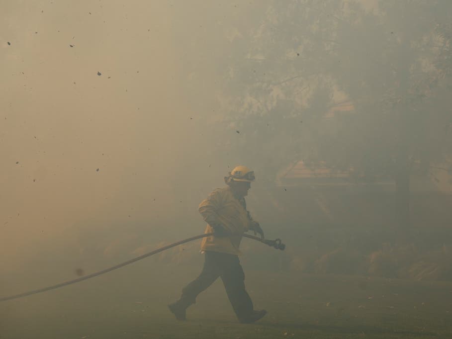 A firefighter works as the Sandy Fire approaches, Tuesday, May 19, 2026, in Simi Valley, Calif.