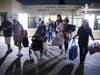 Evacuees from an aerospace chemical plant tank leak move to another shelter after the Garden Grove Sports and Recreation Center closed for the night in Garden Grove, Calif., Friday, May 22, 2026. 