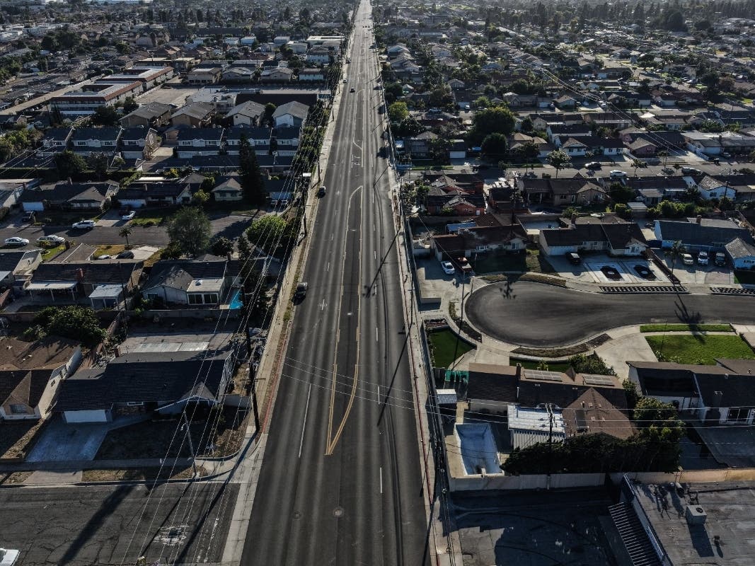 An aerial view shows an empty street within the evacuation zone in Stanton, Calif., Monday, May 25, 2026. (AP Photo/Jae C. Hong)