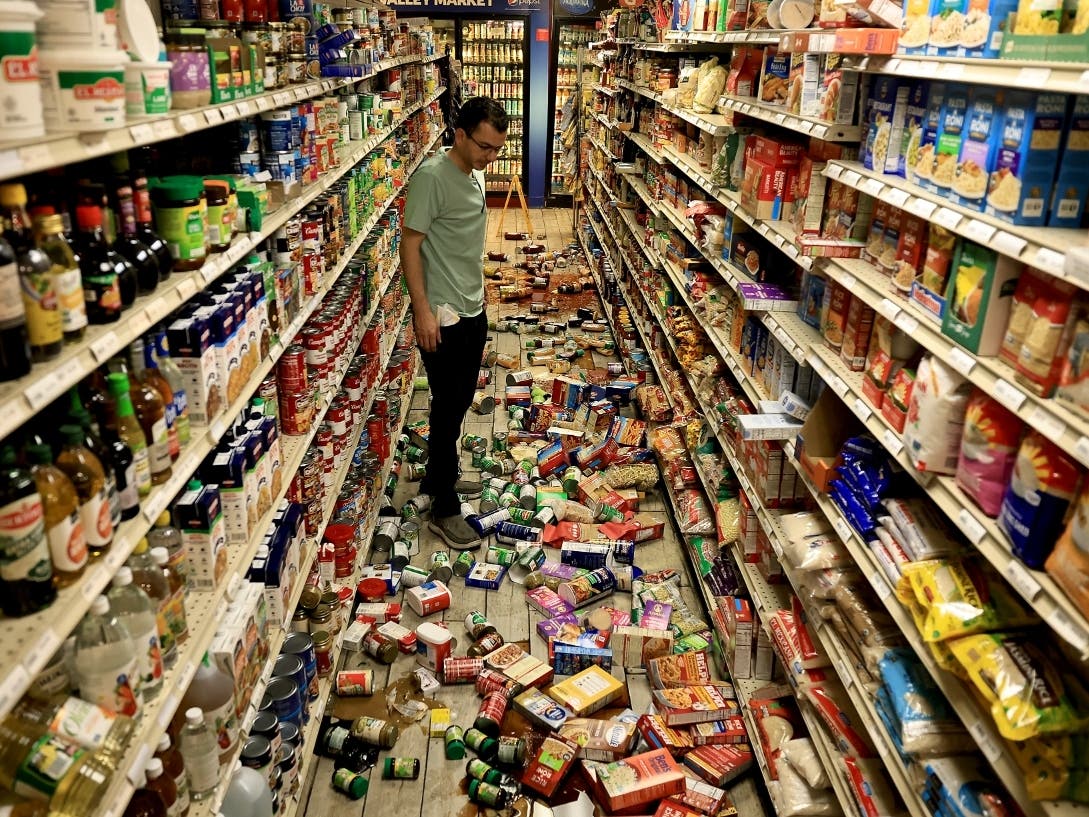 Redwood Valley Market owner Alex Chehada looks at items which fell off the shelves after an earthquake in Redwood Valley, Calif., Wednesday, June 24, 2026.
