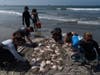 Researchers gather around a pile of stingrays to clip their barbs after catching them in Seal Beach, Calif., Friday, Aug. 7, 2026. 