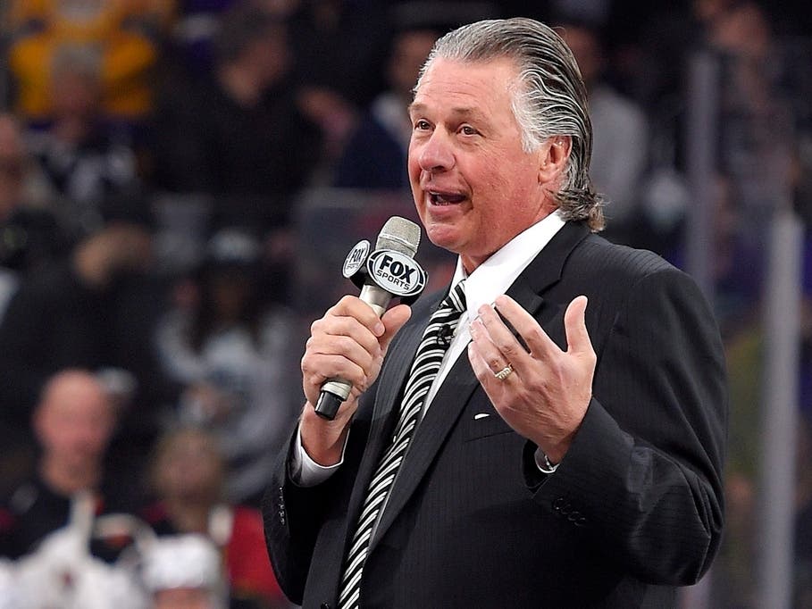 Former Los Angeles Kings coach Barry Melrose speaks to fans as he is honored prior to an NHL hockey game between the Kings and the Calgary Flames, Thursday, Feb. 12, 2015, in Los Angeles. 
