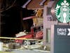 Personnel work at the scene Thursday in McHenry, where a pickup truck drove into a Starbucks.